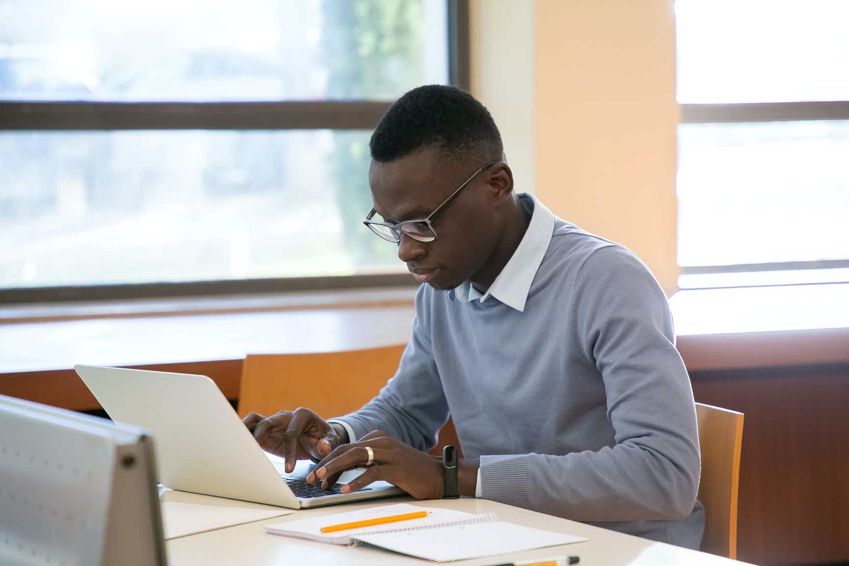 A man works at a laptop